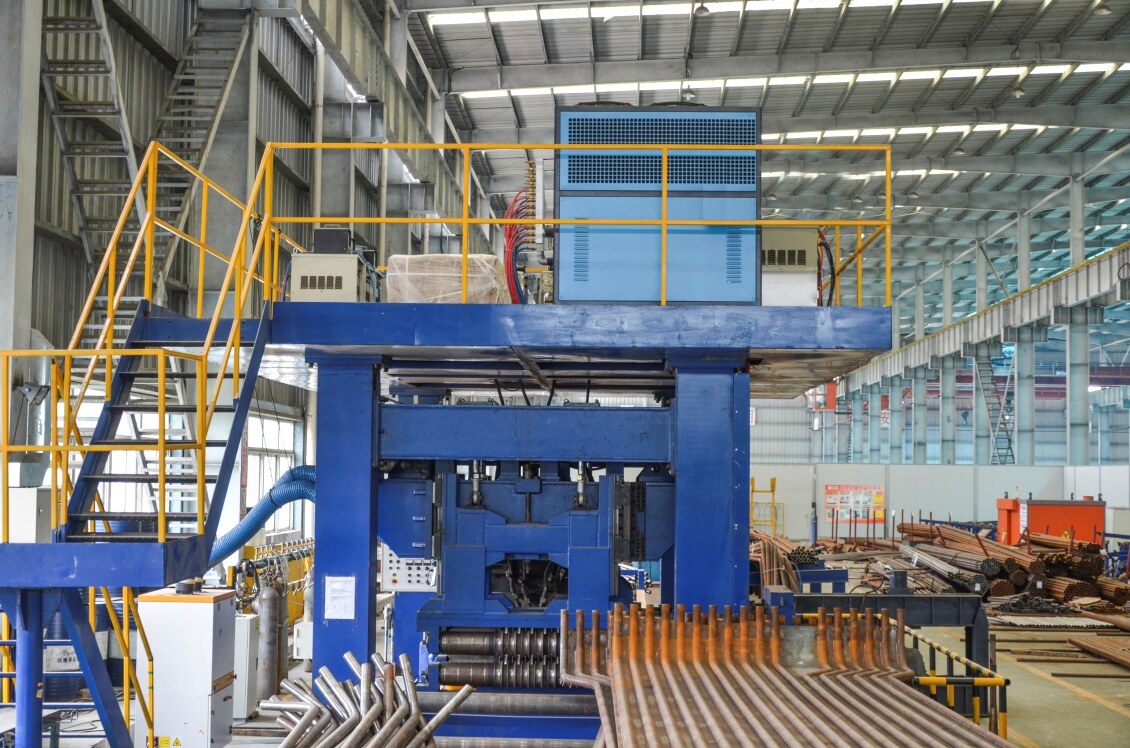 Clear Energy fabrication shop — tube-rolling and welding machine